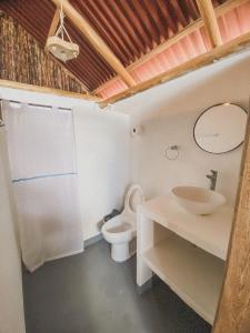RincónMamallena Beachside Rincon del Mar的浴室配有白色卫生间和盥洗盆。