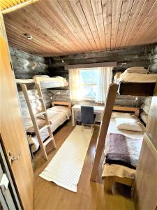 萨利色尔卡Kelo / Lapland, Saariselkä的客房设有三张双层床和一张书桌。