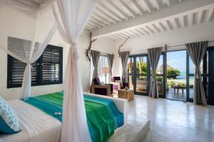 米查维Upendo Beach Boutique Hotel Zanzibar的一间卧室设有一张床,享有海景