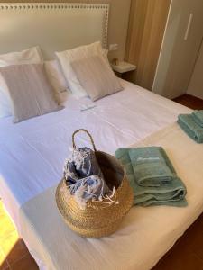 卡兰博希Bonito apartamento con terraza, jardín y piscina的床上一篮子,带毛巾