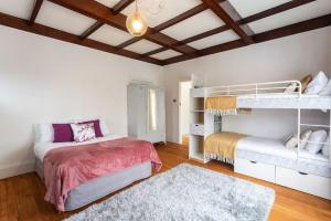 奥克兰Quiet Herne Bay home with 2 bedrooms的卧室配有两张双层床和地毯。