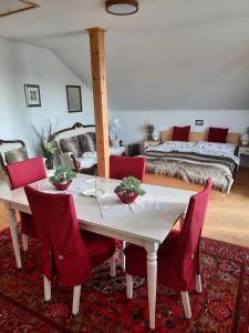 米库洛夫Apartmán Mikulov的一间设有白色桌子和红色椅子的用餐室