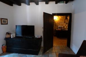 ManurgaMujika Etxea的一间配有电视的客厅和通往走廊的门