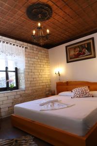 培拉特Vila Darla的一间卧室设有一张大床和砖墙