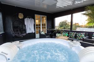 奥尔泽姆Dynasty Home Spa Appartement 100M Jacuzzi Terasse的热水浴池位于客房中间