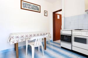 BrijestaApartments by the sea Kabli, Peljesac - 10225的厨房配有桌子和桌椅