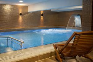 伯萨果茹克勒奥茹科Spa酒店的一个带椅子和水滑梯的游泳池