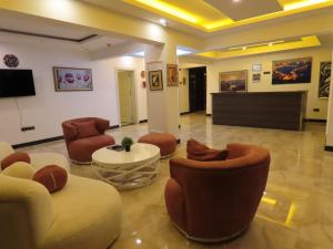 阿拉尼亚Kadeer Hotel的大堂配有沙发、椅子和电视。