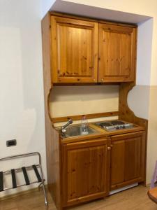 科瓦拉因巴迪亚RESIDENCE MIRAMONTI CORVARA的一个带木制橱柜和水槽的厨房