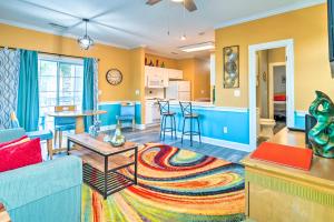 默特尔比奇Colorful Myrtle Beach Golf Club Condo with Pool的客厅和厨房拥有黄色和蓝色的墙壁