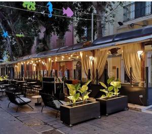 圣安蒂奥科Hotel Del Corso的一间带桌椅和灯光的餐厅