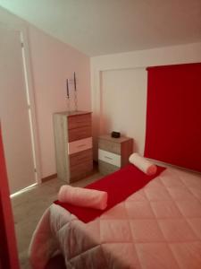 PegalajarALOJAMIENTO RURAL EL CARRIL的一间卧室配有红色的床和梳妆台