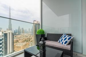 迪拜Ultimate Stay / 4 Beds / Burj Khalifa View / Ultra Modern / Business Bay的公寓的阳台配有沙发和桌子。