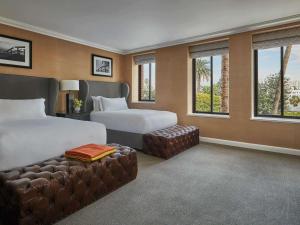 洛杉矶费尔蒙米拉马尔酒店&单层小屋的酒店客房带两张床、一张沙发和窗户。