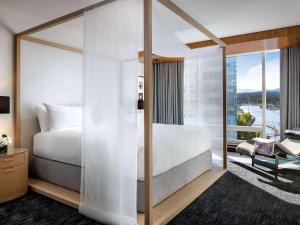 温哥华费尔蒙特环太平洋酒店的一间卧室设有一张大床和一个大窗户