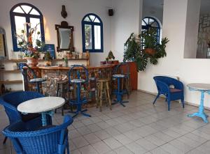 阿梅尼斯蒂斯Daidalos Hotel的餐厅内带蓝色桌椅的酒吧