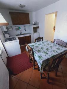 卡普拉罗拉La Casetta的带桌椅的厨房以及带桌子和桌子的厨房。