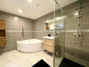 勒芒Residence Belfort的带浴缸、水槽和淋浴的浴室