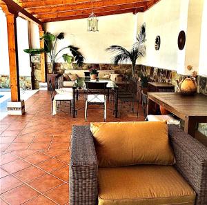 La CodoseraCasa Rural Los Olmos的客厅设有沙发,位于庭院