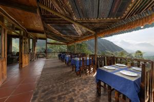 萨帕Chapa Farmstay - Mountain Retreat的阳台餐厅,配有桌椅
