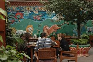 加德满都西藏宾馆的一群坐在壁画前桌旁的人