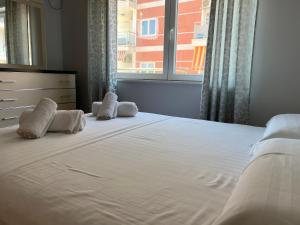 维利波吉Bella View Apartment的一间卧室配有带两个枕头的床和窗户