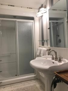滨湖尼亚加拉Upper Canada Coach House的带淋浴和盥洗盆的白色浴室