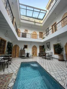 马拉喀什Riad Le Petit Joyau的大型客房的室内游泳池,设有天花板