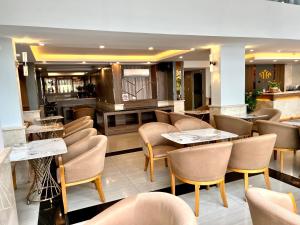 胡志明市Nam Hy 1 Hotel的一间在房间内配有桌椅的餐厅
