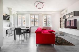 米兰Garibaldi & Gae Aulenti Modern Apt with Private Parking!的客厅配有红色的沙发和桌子