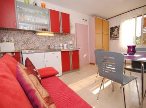 布雷拉Antique apartment in the center of Brela的一间带红色沙发的客厅和一间厨房