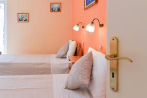 派莱卡斯Villa Myrto的橙色墙壁客房的两张床