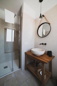 奇斯泰尼诺Dimorae Camà的一间带水槽、淋浴和镜子的浴室