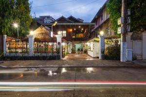 暹粒Happy Heng Heang Guesthouse的夜间有门和汽车的城市街道