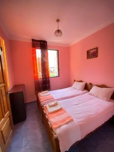 高尼奥Holiday Home in Gonio的一间卧室设有两张床和窗户。