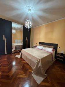 贝内文托Malies B&B的一间卧室配有一张大床和一个吊灯。