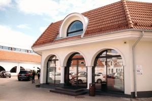 塔林布拉沃温泉酒店的一座建筑,设有拱形窗户和红色屋顶