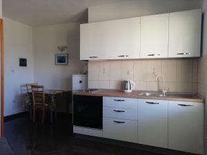 马拉诺维奇Apartments by the sea Cove Saplunara, Mljet - 4896的厨房配有白色橱柜和水槽