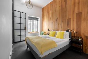布达佩斯阿斯托里亚阁楼酒店的一间卧室设有一张带木墙的大床