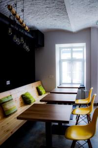 弗罗茨瓦夫FOKA Hostel的客房设有木桌、黄色椅子和窗户。