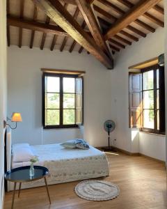 Pietrafitta阿巴其亚赛特弗拉迪弗拉特利斯农家乐的卧室配有床、桌子和窗户。