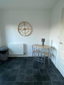 麦斯堡Kingfisher House的墙上有桌子和时钟的房间