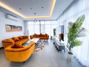 Al ‘AqarOlivia Chalet فلة أوليفيا的客厅配有两张沙发和一台电视机