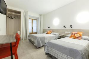 马德里卡斯蒂利亚二世太阳门旅馆的酒店客房设有两张床和电视。