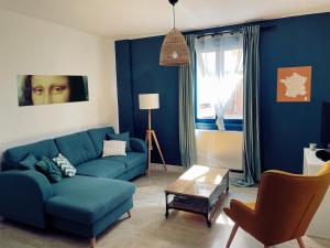 阿姆博斯Amboise - L'écrin de Léonard的客厅配有蓝色的沙发和桌子