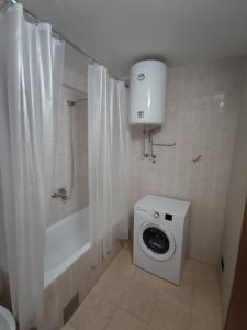 巴尔Guest House Tomba的一间带卫生间、淋浴和洗衣机的浴室