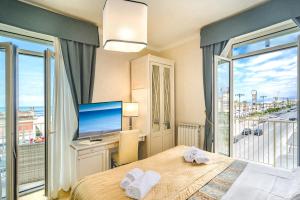 维亚雷焦拉佩斯酒店的一间卧室设有一张床、一台电视和一个窗口。