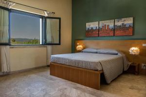 蒙特梅拉诺波焦酒店的一间卧室设有一张床和一个大窗户