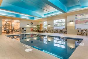 巴瑟斯特贝斯特韦斯特PLUS巴瑟斯特酒店及套房的一个带蓝色天花板和桌椅的游泳池