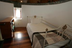 七城奥姆胡达比比度假屋的一间卧室配有一张床,铺有木地板